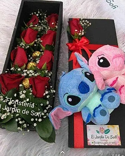 Dos cajas negras con rosas rojas y pareja de peluches